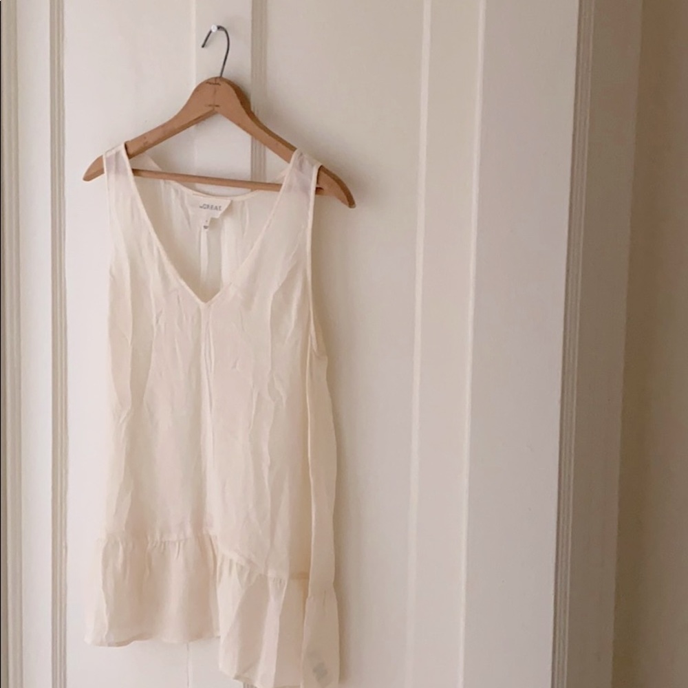 The Great sleeveless peplum ivory silk top